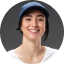 Person wearing a dark hat and glasses smiling at the camera in a circular profile photo