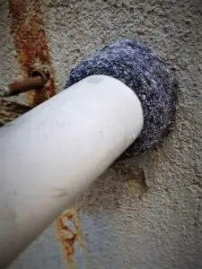 Steel wool around plumbing pipe mouse proofing